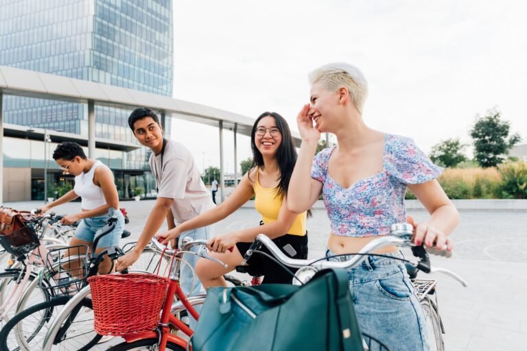 Group multiethnic friends outdoor riding bicycle
